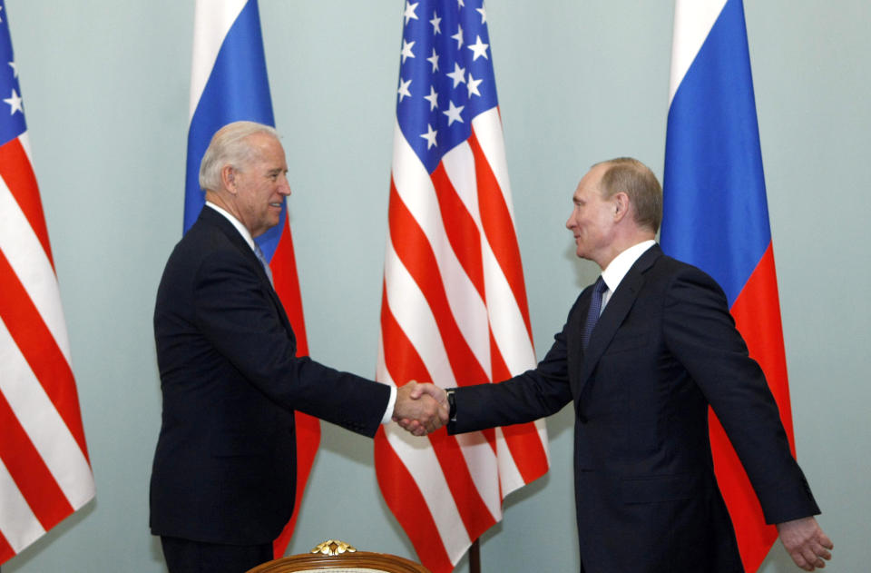 FILE - In this March 10, 2011 file photo, then U.S. Vice President Joe Biden, left, shakes hands with Russian Prime Minister Vladimir Putin in Moscow. (AP Photo/Alexander Zemlianichenko)