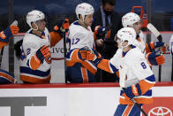 New York Islanders defenseman Noah Dobson (8) is congratulated for his goal during the first period of the team's NHL hockey game against the Washington Capitals, Tuesday, Jan. 26, 2021, in Washington. (AP Photo/Nick Wass)