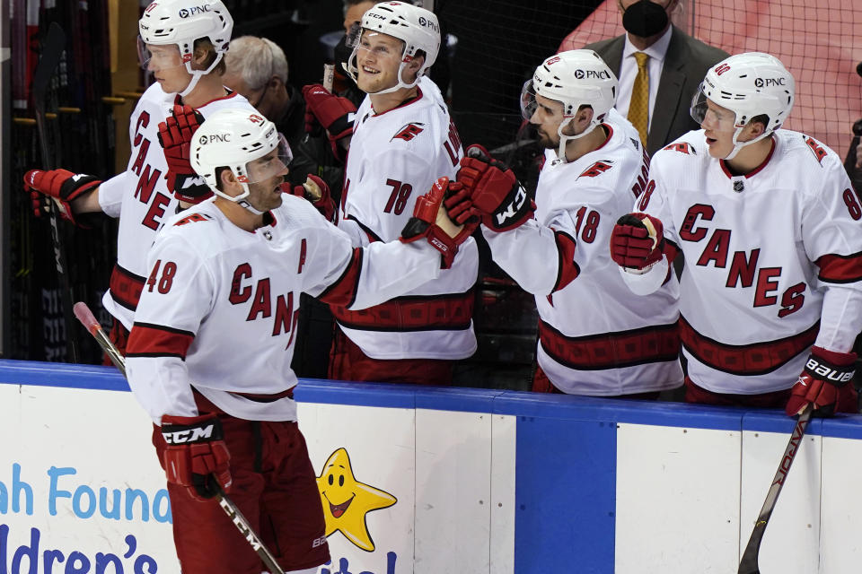 Carolina Hurricanes left wing Jordan Martinook (48) is congratulated by teammates after scoring a goal during the second period of an NHL hockey game against the Florida Panthers, Thursday, April 22, 2021, in Sunrise, Fla. (AP Photo/Marta Lavandier)