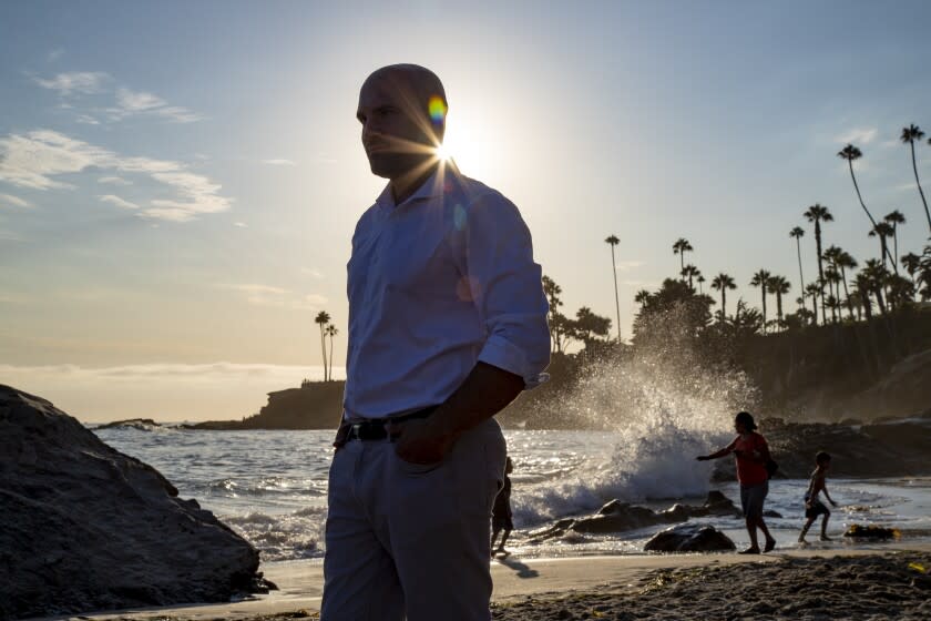 LAGUNA BEACH, CA - JULY 28, 2022: Kevin McCarthy of Laguna Beach enjoys his freedom and the warm sun on his back at Main Beach after being held in solitary confinement at Pelican Bay for 10 years on July 28, 2022 in Laguna Beach, California.He got out of prison 2 yers ago and is now in the process of applying to law school. He is advocating for a bill AB 2632, which would curtail the use of solitary in state prisons. (Gina Ferazzi / Los Angeles Times)