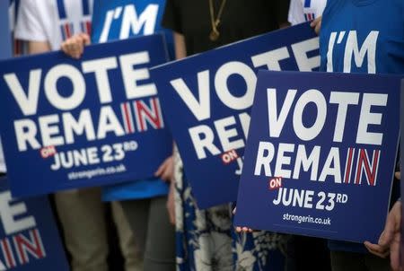 Campaigners hold placards as British Prime Minister David Cameron delivers a speech at a 'Stronger In' campaign event in Witney, Oxfordshire, Britain, 14 May 2016. REUTERS/WILL OLIVER / POOL