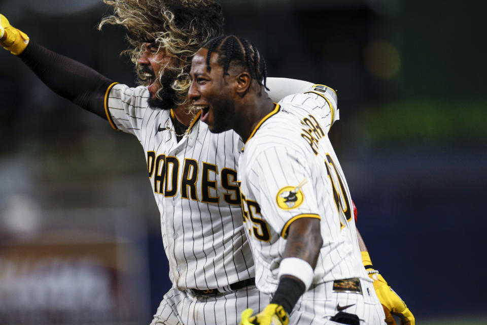 San Diego Padres' Jorge Alfaro, left, celebrates with Jurickson Profar after hitting a two-run single against the Arizona Diamondbacks during the ninth inning of a baseball game Tuesday, Sept. 6, 2022, in San Diego. (AP Photo/Brandon Sloter)