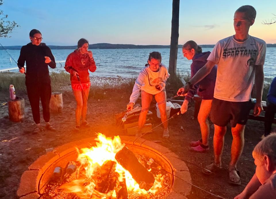 Campers join each other around the fire for some late night marshmallows and s'mores at Park of the Pines in Boyne City recently.