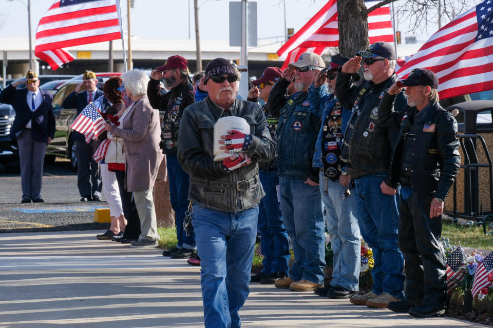 Veterans salute in honor as the remains of a Vietnam veteran are carefully transported Wednesday at the Texas Panhandle War Memorial Center's service, which honored those service members who were identified from the unclaimed cremated bodies found in storage in the region.