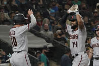 Arizona Diamondbacks' Henry Ramos (14) is greeted by Josh Rojas (10) after hitting a two-run home run to score them both during the second inning of a baseball game against the Seattle Mariners, Friday, Sept. 10, 2021, in Seattle. (AP Photo/Ted S. Warren)
