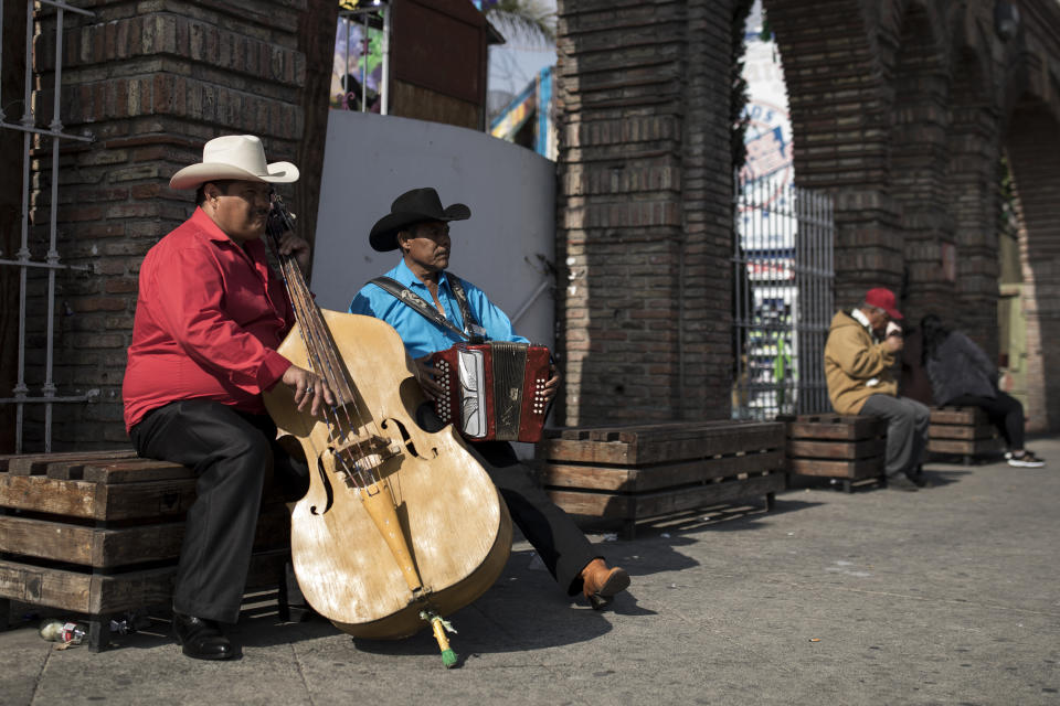 Musicians perform near the plaza where Mexican President Andres Manuel Lopez Obrador will hold a rally, in Tijuana, Mexico, Saturday, June 8, 2019. Mexican President Andres Manuel Lopez Obrador is to hold a rally in Tijuana even as President Trump has put on hold his plan to begin imposing tariffs on Mexico on Monday, saying the U.S. ally will take "strong measures" to reduce the flow of Central American migrants into the United States. (AP Photo/ Hans-Maximo Musielik)