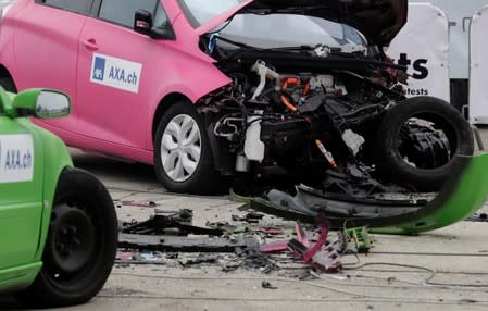 A Renault Zoe electric car (R) is seen after collision with an oncoming Volvo V70 car in a controlled crash test from insurer AXA in Duebendorf