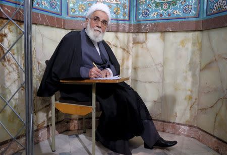 Iran's former Parliament speaker Ali Akbar Nateq-Nouri fills in his ballot during elections for the parliament and Assembly of Experts, which has the power to appoint and dismiss the supreme leader, in Tehran February 26, 2016. REUTERS/Raheb Homavandi/TIMA