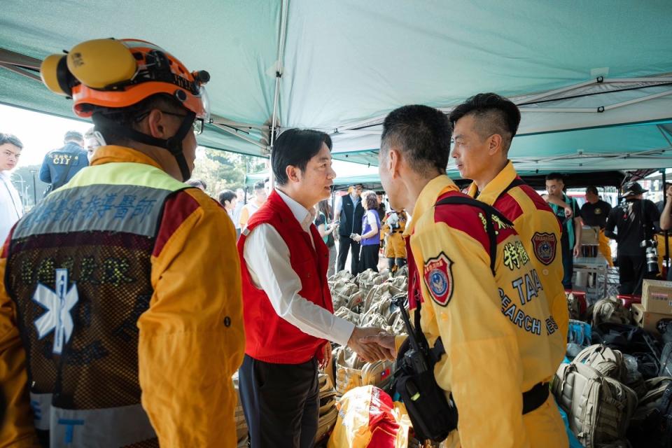 Taiwan’s President Elect and Vice President Lai Ching-te, center, shakes hands with rescue workers as he visits quake hit city of Hualien in eastern Taiwan.<span class="copyright">Taiwan Presidential Office/AP</span>