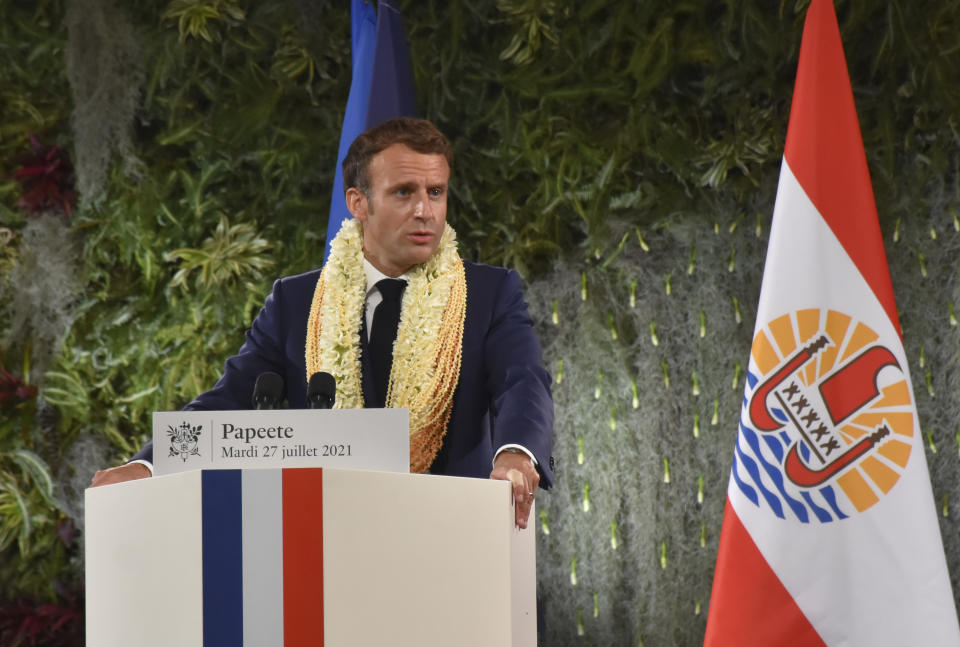 France's President Emmanuel Macron France's President wearing a flower lei and seashell necklaces delivers a speech after a meeting with the President of the French Polynesia Edouard Fitch in Tahiti, French Polynesia in the Pacific Ocean, Tuesday, 27, 2021.President Emmanuel Macron reasserted France's presence in the Pacific on a visit to French Polynesia aimed in part at countering growing Chinese dominance in the region. (AP Photo/Esther Cuneo)