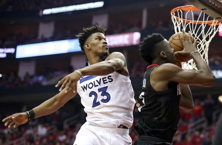 FILE PHOTO: Apr 25, 2018; Houston, TX, USA; Houston Rockets center Clint Capela (15) drives past Minnesota Timberwolves guard Jimmy Butler (23) for the basket in the second half in game five of the first round of the 2018 NBA Playoffs at Toyota Center. Mandatory Credit: Thomas B. Shea-USA TODAY Sports/File Photo