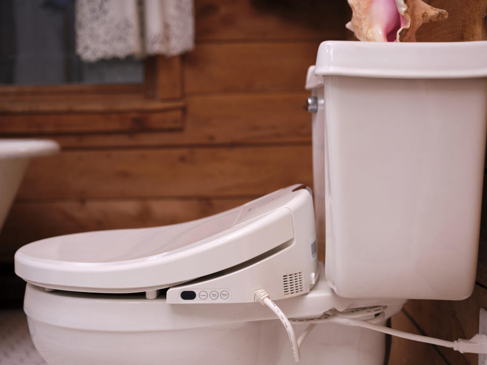 Modern bidet toilet with control panel at a home's bathroom