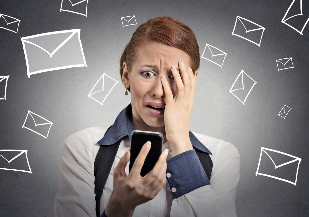 Upset stressed woman holding cellphone disgusted shocked with message she received isolated grey background. Funny looking human face expression emotion feeling reaction life perception body language