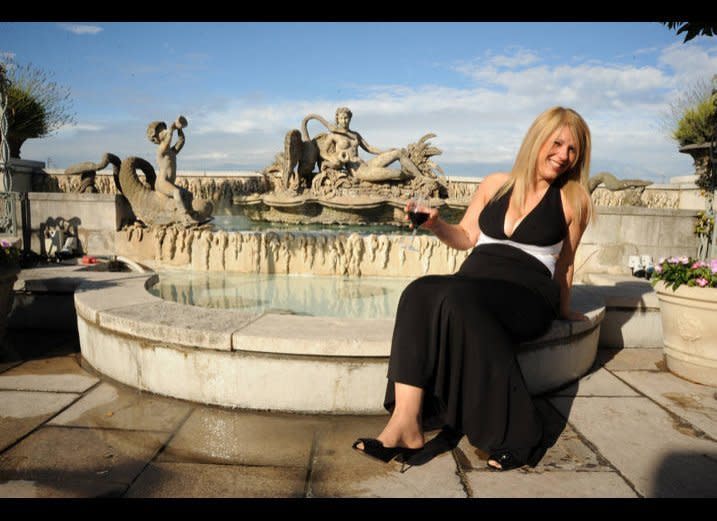 Before moving home to help her mother, Jeanne was living and working abroad in London. Here, she poses on her wedding day on top of the Dorchester Hotel.