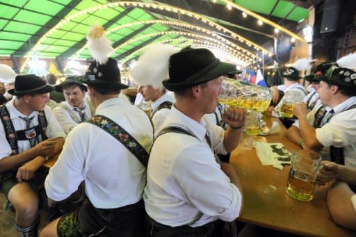 Visitors dressed in traditional Bavarian clothes drink beer at the Theresienwiese Oktoberfest fair grounds in Munich, Germany. With about eight million beers downed each year at the Oktoberfest, you might expect a few items to go awry, but the lost-and-found office at the world's top beer fest really has seen it all