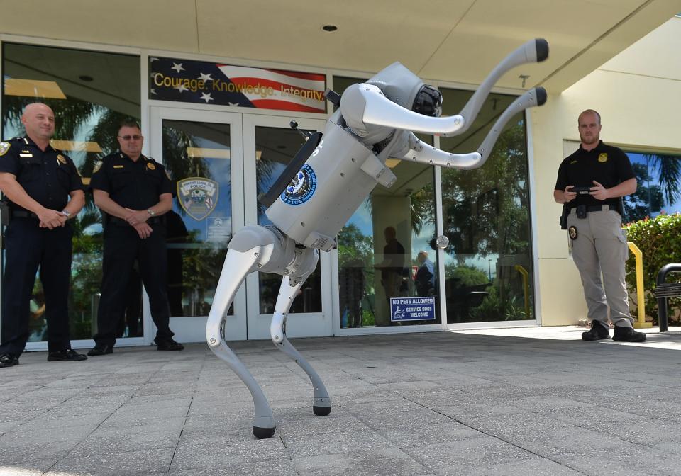 Port St. Lucie Police Department officials (from left) Acting Police Chief Richard Del Toro and Assistant Chief Leo Niemczyk, stand by as Detective Kevin Fry operates the department’s new Unitree Go2 robotic dog in front of the Port St. Lucie Police Department on Southwest Port St Lucie Boulevard, Thursday, June 27, 2024. The robotic dog will assist police officers during high-risk incidents.