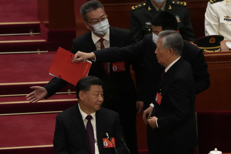 Chinese President Xi Jinping at left looks on as former Chinese President Hu Jintao is assisted to leave the hall during the closing ceremony of the 20th National Congress of China's ruling Communist Party at the Great Hall of the People in Beijing, Saturday, Oct. 22, 2022. Former Chinese President Hu Jintao, Xi's predecessor as party leader, was helped off the stage shortly after foreign media came in, sparking speculation about his health. (AP Photo/Ng Han Guan)