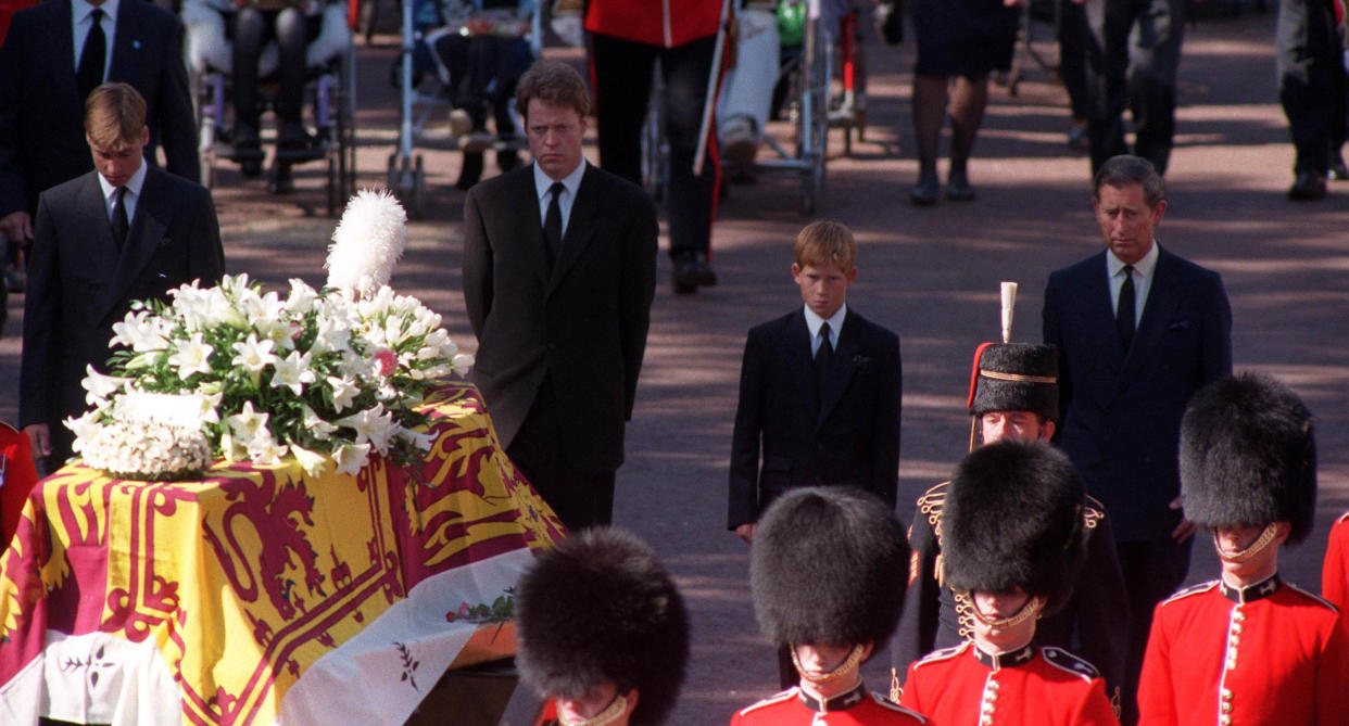 Prince William and Prince Harry walk behind their mother's coffin