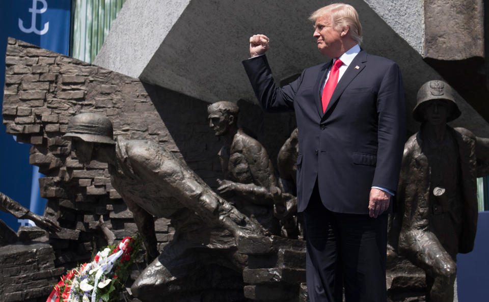 Trump clenches his fist as he stands in front of the Warsaw Uprising Monument.&nbsp;