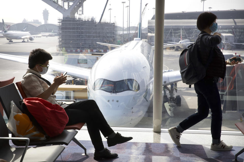 Travelers wear face masks as they wait their flight at Hong Kong International Airport in Hong Kong, Tuesday, Jan. 21, 2020. Face masks sold out and temperature checks at airports and train stations became the new norm as China strove Tuesday to control the outbreak of a new coronavirus that has reached four other countries and territories and threatens to spread further during the Lunar New Year travel rush. (AP Photo/Ng Han Guan)