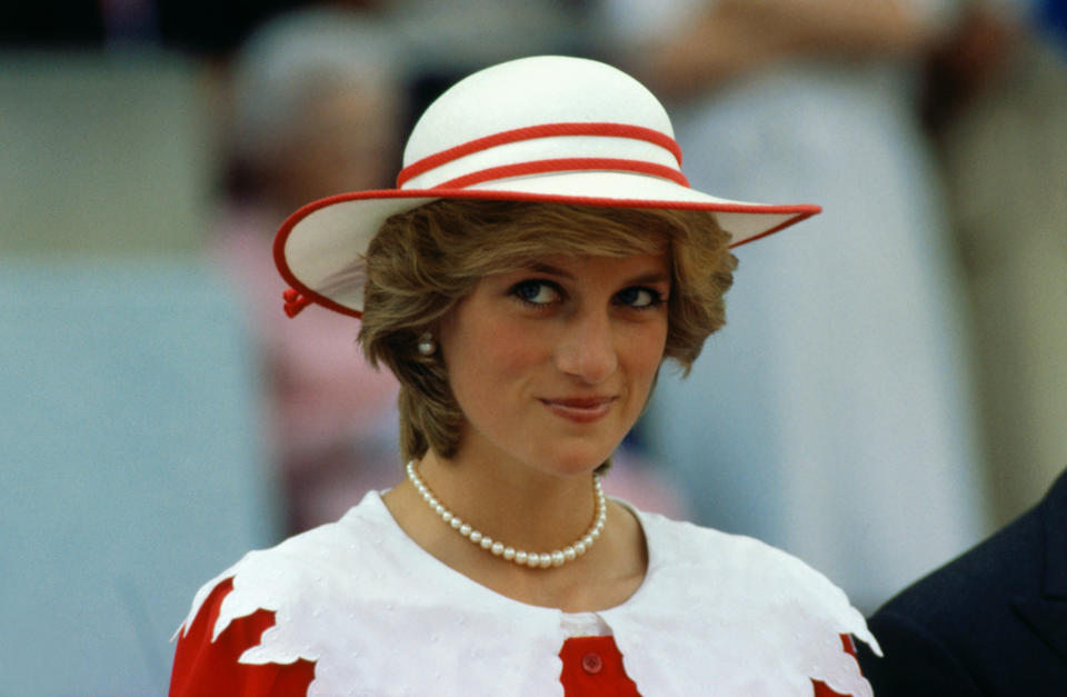 Diana, Princess of Wales, wears an outfit in the colors of Canada during a state visit to Edmonton, Alberta, with her husband.