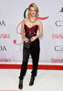 January Jones in a J. Mendel pantsuit with a wrapped, abs-baring bodice, bold accessories (including a Rauwolf clutch) and a fabulously funky necklace courtesy of her date Irene Neuwirth.