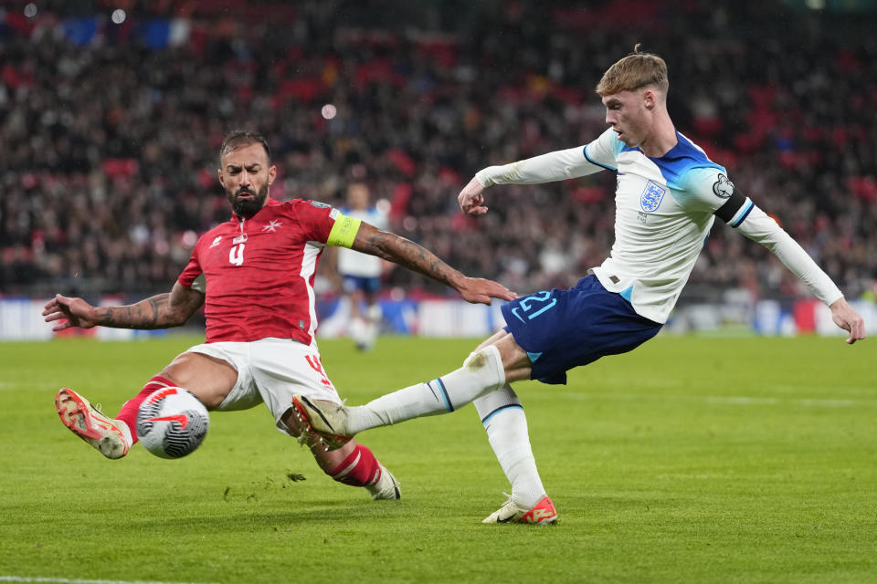 England's Cole Palmer kicks the ball ahead of Malta's Steve Borg during the Euro 2024 group C qualifying soccer match between England and Malta at Wembley stadium in London, Friday, Nov. 17, 2023. (AP Photo/Kirsty Wigglesworth)