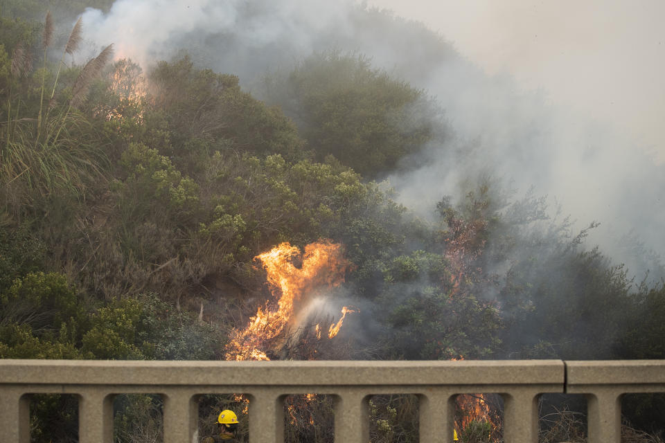 Firefighters with Vandenberg Air Force Base, light a back burn to help control the Dolan Fire at Limekiln State Park in Big Sur, Calif,. Friday, Sept. 11, 2020. (AP Photo/Nic Coury)