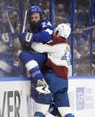 Tampa Bay Lightning defenseman Zach Bogosian (24) is checked by Colorado Avalanche center Darren Helm (43) during the second period of Game 6 of the NHL hockey Stanley Cup Finals on Sunday, June 26, 2022, in Tampa, Fla. (AP Photo/Phelan Ebenhack)