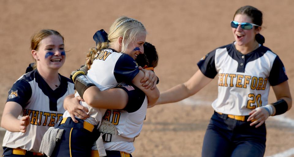 Pitcher Unity Nelson of Whiteford lifted by her catcher Kaydence Sheldon after they beat Laingsburg 8-0 in the Division 3 state semifinals at Seehia Stadium, MSU Friday, June 16, 2023. Other players charging in Karlei Conard and Allison Spradling. 