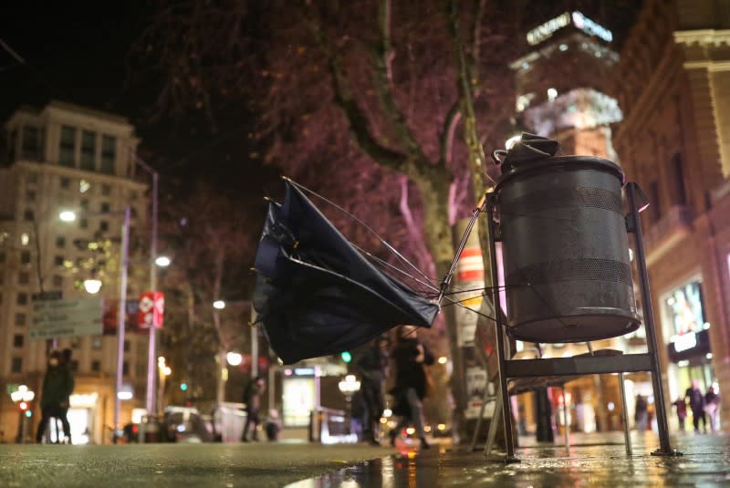 Broken umbrellas are pictured on a waste bin during the storm "Gloria" on a street in Barcelona