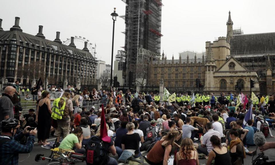 Protesters sit in the road in Parliament Square