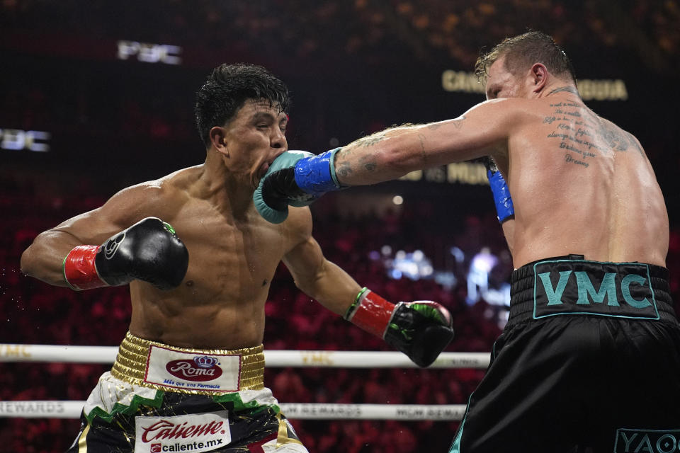 Canelo Alvarez hits Jaime Munguia in a super middleweight title fight Saturday, May 4, 2024, in Las Vegas. (AP Photo/John Locher)