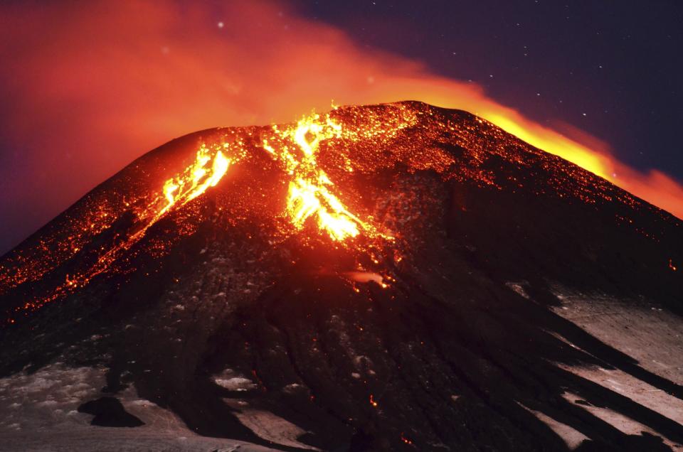 Ash and lava spew from the Villarrica volcano, as seen from Pucon town in the south of Santiago, March 3, 2015. Volcano Villarrica in southern Chile erupted in the early hours of Tuesday, sending a plume of ash and lava high into the sky, and forcing the evacuation of nearby communities. (REUTERS/Lautaro Salinas)