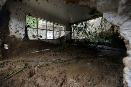 A resident shows a classroom damaged by a mudslide following heavy showers caused by the passing of Tropical Storm Earl, in the town of Temazolapa, in Veracruz state, Mexico, August 6, 2016. REUTERS/Oscar Martinez