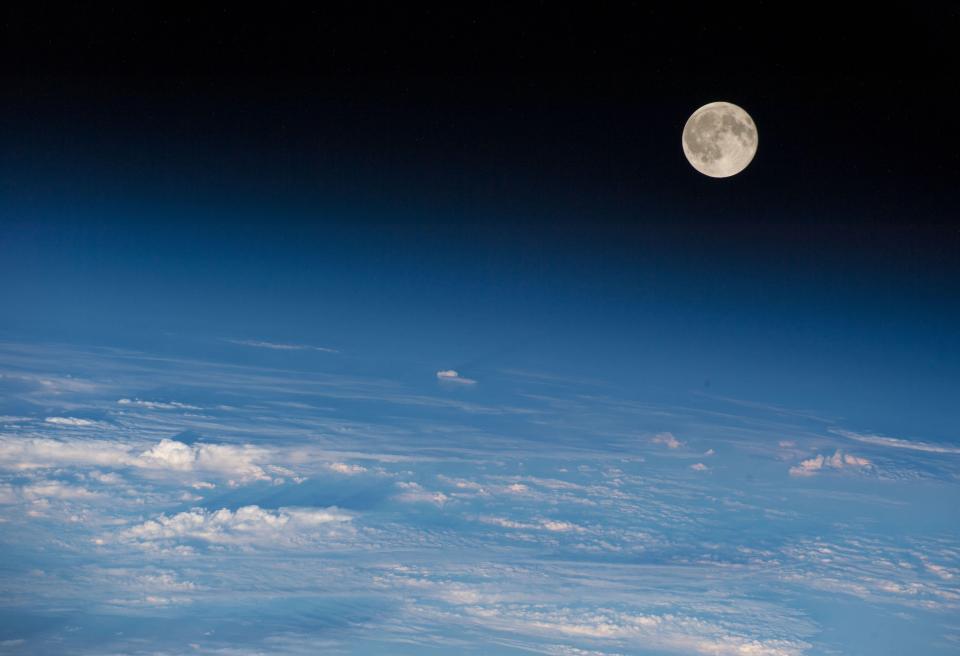 Moon rising over the Earth, seen from space (Rex)