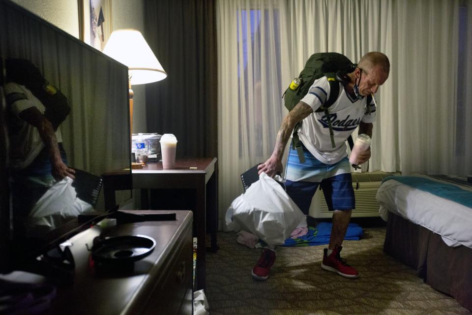 Kenneth Colato prepares to leave Lauren's room at the Airtel Plaza in Van Nuys.