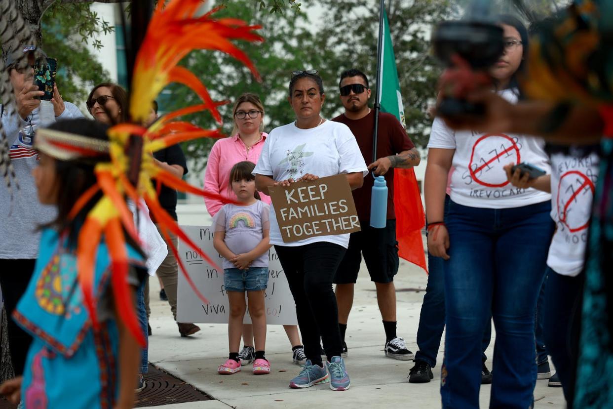 People participate in an immigration rally in Homestead, Fla., in June 2023. <a href="https://www.gettyimages.com/detail/news-photo/people-join-together-for-a-freedom-for-all-rally-on-july-01-news-photo/1507820007?adppopup=true" rel="nofollow noopener" target="_blank" data-ylk="slk:Joe Raedle/Getty Images;elm:context_link;itc:0;sec:content-canvas" class="link ">Joe Raedle/Getty Images </a>