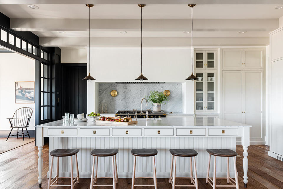 For a client who preferred closed storage, the W Design Collective team designed a floor-to-ceiling pantry outfitted with ample spice racks, shelves and drawers to keep dry goods organized