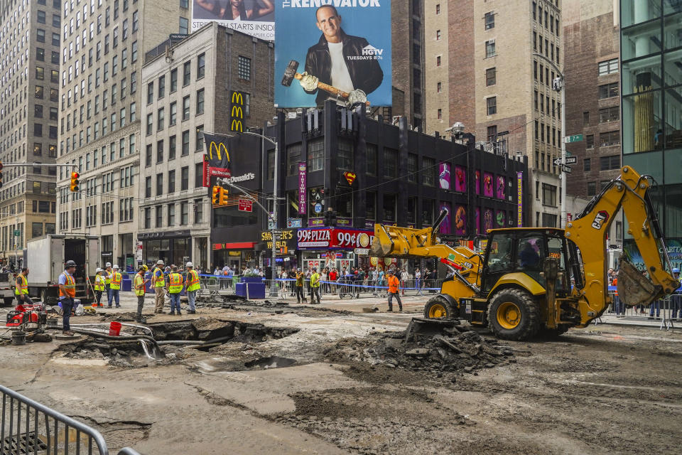 Work crews begin repair after a 127-year-old water main under New York's Times Square gave way under 40th Street and Seventh Avenue at 3 a.m., flooding streets and subways, Tuesday Aug. 29, 2023, in New York. (AP Photo/Bebeto Matthews)