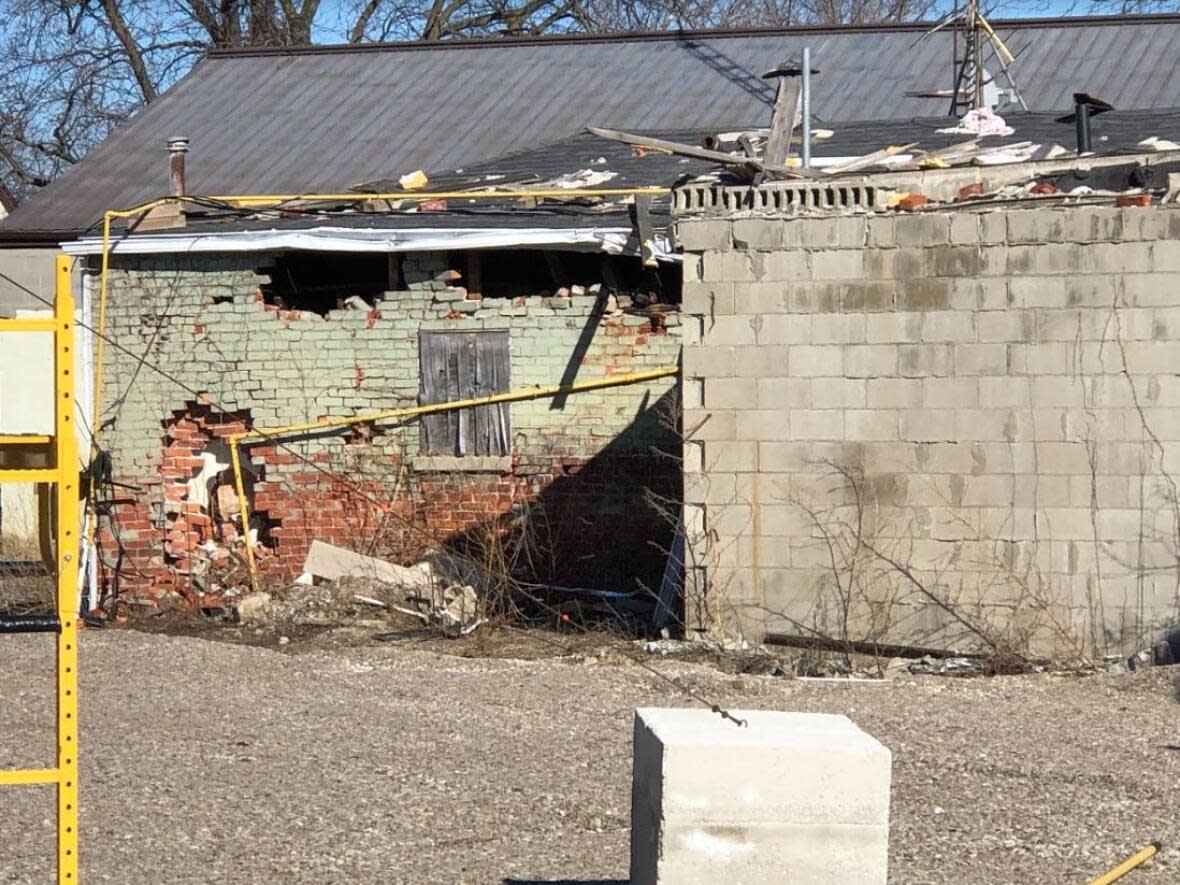 Damage to a building in the Wheatley evacuation zone remaining after an explosion occurred nearby in August 2021. The municipality of Chatham-Kent is discussing purchasing this property and 10 others that are part of the zone. (TJ Dhir/CBC - image credit)