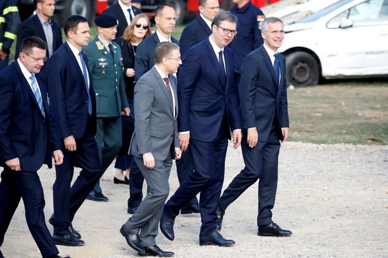 FILE PHOTO: Serbian President Aleksandar Vucic and NATO Secretary-General Jens Stoltenberg attend an international field exercise in Mladenovac