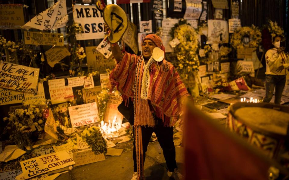 Performers visit a memorial where two people died during the November 14 protests against the removal of President Martin Vizcarra - AP