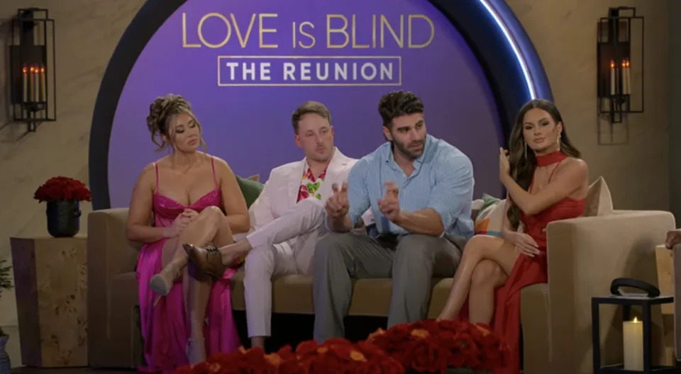 Sarah Ann, Jeramy, Trevor, and Jessica on a 'Love is Blind, the Reunion' set with flowers, speaking into microphones