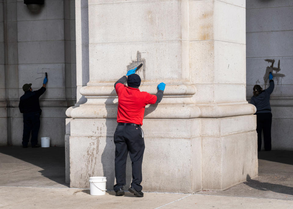 WASHINGTON, D.C., 2022: Workers clean swastikas off the exterior of Union Station. <span class="copyright">Tom Williams—CQ-Roll Call, Inc/Getty Images</span>