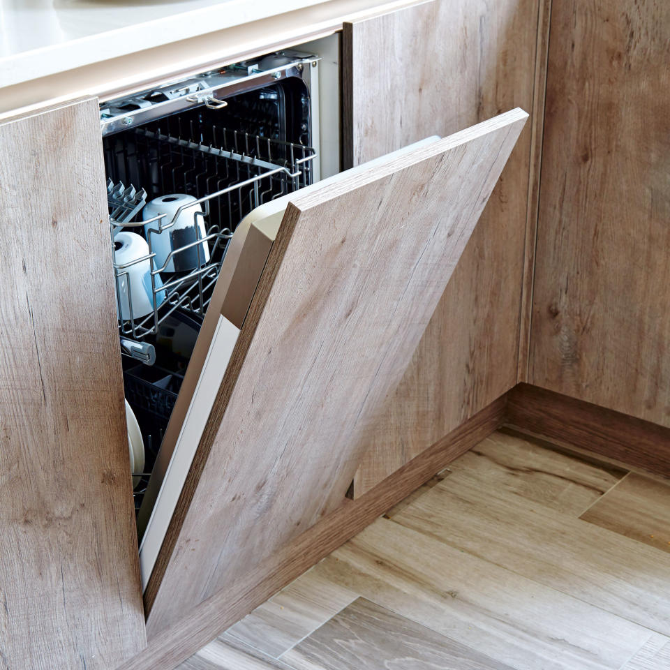 concealed wooden door dishwasher in kitchen