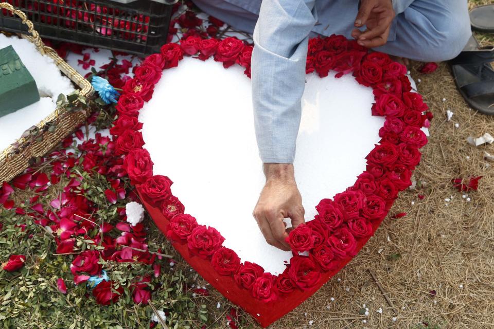 Romance scam A vendor prepares a heart-shaped flower bouquet at a flower shop on Valentine's Day in Islamabad, capital of Pakistan, Feb. 14, 2022. TO GO WITH 