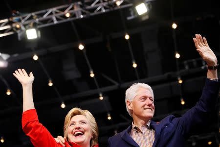 Democratic presidential candidate Hillary Clinton waves to the crowd with her husband, former president Bill Clinton at the David L. Lawrence Convention Center in Pittsburgh, Pennsylvania, July 30, 2016. REUTERS/Aaron P. Bernstein