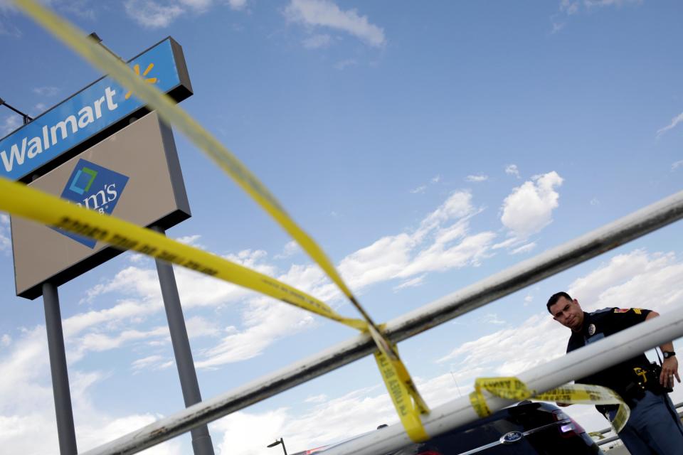 FILE PHOTO: A police officer stands next to a police cordon after a mass shooting at a Walmart in El Paso,Texas, U.S. August 3, 2019. REUTERS/Jose Luis Gonzalez/File Photo