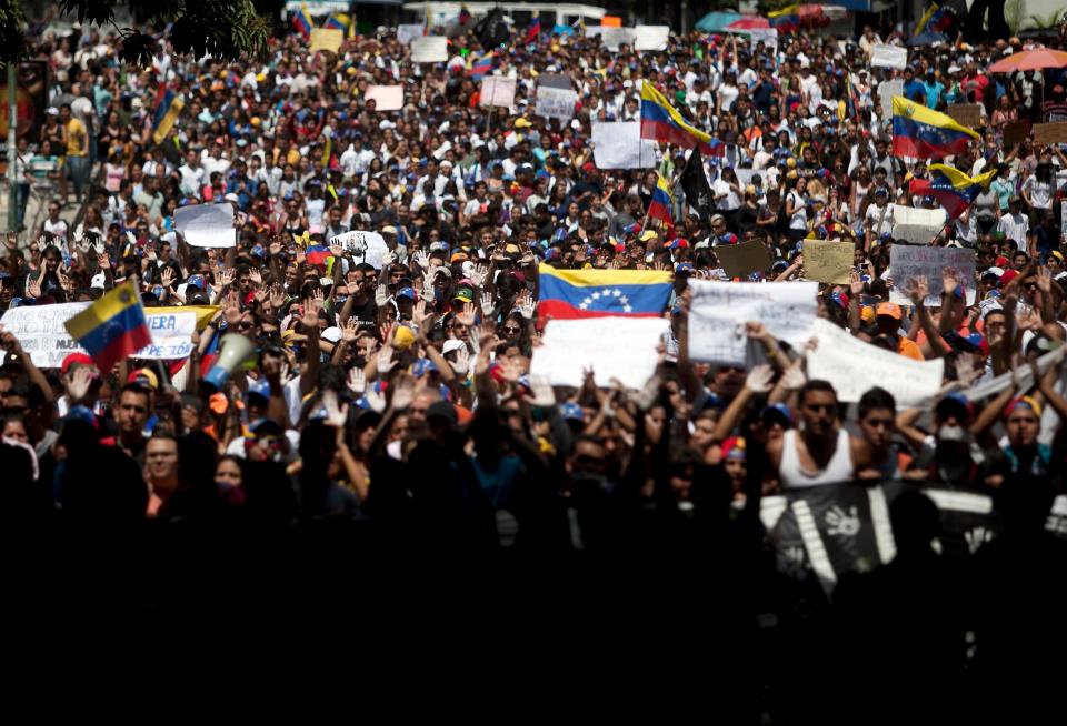 Students shout slogans against Venezuela's President Nicolas Maduro during a march to the Venezuelan Telecommunications Regulator Office or CONATEL in Caracas, Venezuela, Monday, Feb17, 2014. More students, who’ve spent the past week on the streets alternating between peaceful protests by day and battles with police at night, marched on Monday to Venezuela’s telecom regulator to demand it lift all restrictions on media’s coverage of the unfolding political crisis. (AP Photo/Alejandro Cegarra)